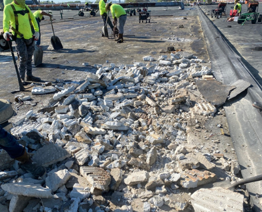 Workers removing debris from roof