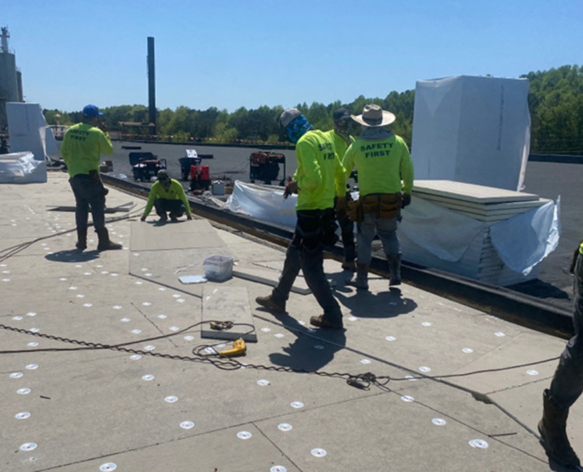 Workers walking on flat roof