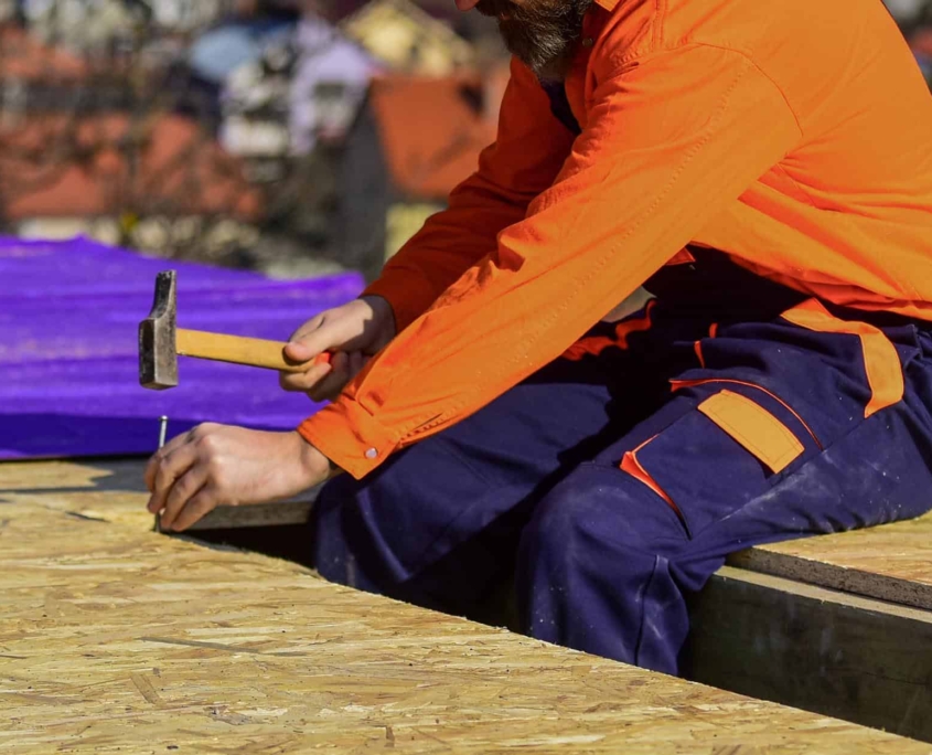 Worker Sitting Ontop Of Commercial Roof Decking