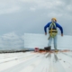 Worker Installing Metal Roof Panels